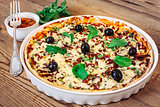 Pizza homemade with sauce on wooden background