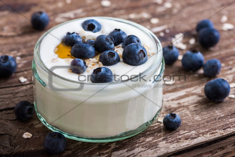 Detail of Yogurt with Fresh Blueberries on Woden Table