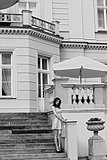 BW image vintage palace , with pink woman on stairs