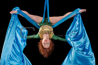 Young woman training on aerial silk