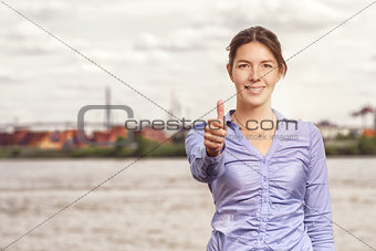 Happy smiling woman giving a thumbs up