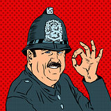 English policeman in uniform and helmet shows gesture OK