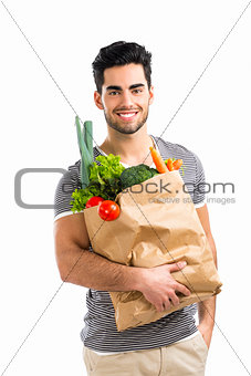Man carrying a bag full of vegetables