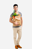 Man carrying a bag full of vegetables