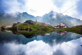 Idyllic view with typical lodges on Balea Lake shore in Fagaras 