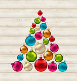 Christmas tree made of colorful balls on wooden background 