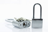 Metallic padlock with  keys on white background