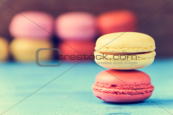 macarons on a blue rustic surface, cross processed