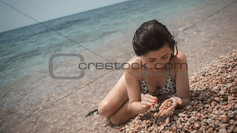 young girl the teenager on a sea beach