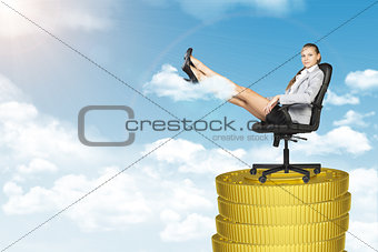 Businesslady sitting in chair on coins stack