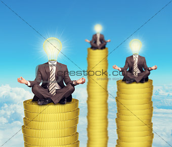 Sitting businessmen on coins steps