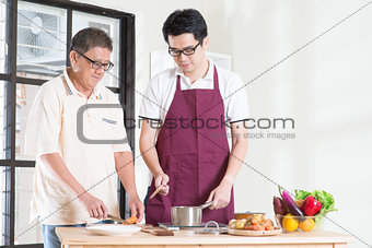 Father and son cooking
