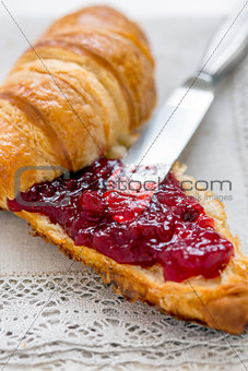 Croissant with jam for breakfast.