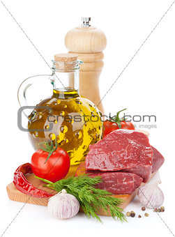 Raw fillet beef steak and spices on cutting board