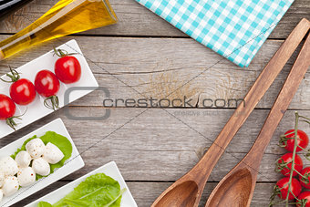Fresh healthy salad, tomatoes, mozzarella on wooden table