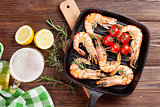 Grilled shrimps on frying pan and beer
