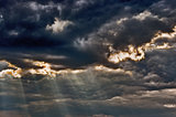 Stormy sky with a dramatic sunbeams