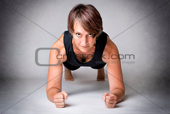 Middle aged woman forearm push-ups