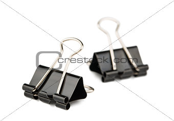 Two metal paper binder clips