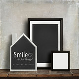 Chalkboard with quote and frames on table