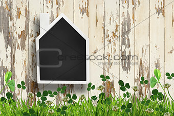 House shaped chalkboard on wooden background