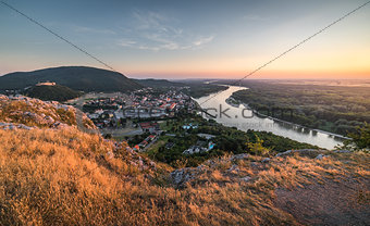 View of Small City with River from the Hill at Sunset