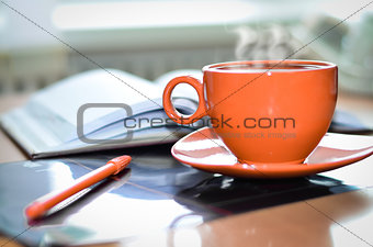 Cup of coffee on the desk in the office