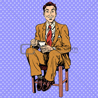 Man drinking tea sitting on the stool