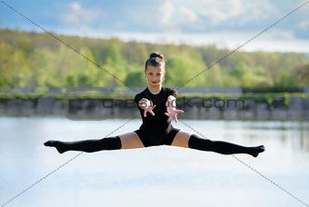 Young Gymnast is Up in the Air Doing Leg-Split