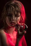 sexy girl in half-light with apple  