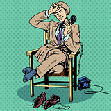 Tired man sits chair talking phone
