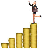 Businesslady with suitcase on gold coins stack 