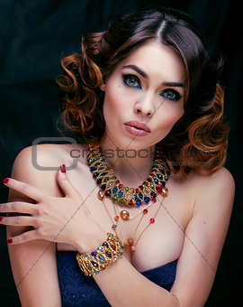 beauty rich woman with luxury jewellery looks like mature close up
