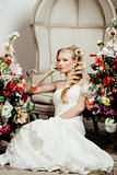 beauty young bride alone in luxury vintage interior with lot of flowers