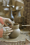 hands making clay pot