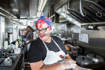 Pink Haired Chef Wearing Gloves Aboard Food Truck
