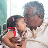 Grandfather kissing granddaughter 