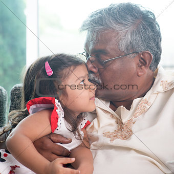 Grandfather kissing granddaughter 