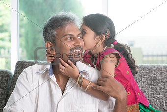 Daughter kissing dad