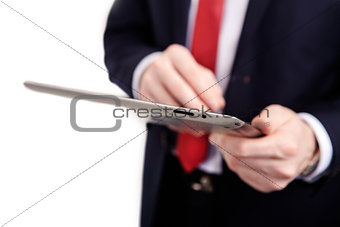 Tablet PC in the hands of a man in a suit on an isolated white