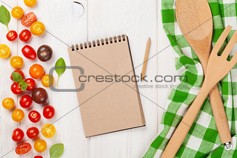 Colorful cherry tomatoes and kitchen utensils