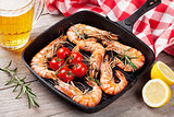 Grilled shrimps on frying pan and beer