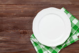 Empty plate over wooden table