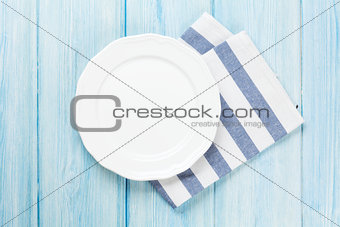 Empty plate over wooden table background