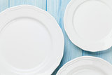 Empty plates over wooden table
