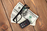 Money cash, glasses and car remote key