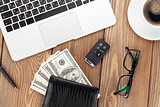 Office table with pc, coffee cup, glasses and money cash