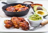 Grilled chicken legs and wings with guacamole