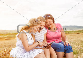 Group of friends outdoors with a tablet
