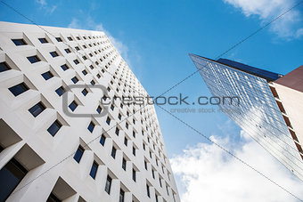 Fragment of a glass skyscraper merged with blue sky